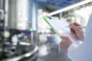 quality inspector holding clipboard performing BRCGS certification