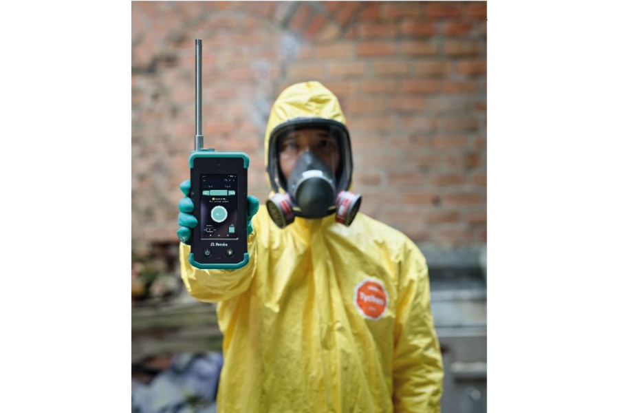 Person in PPE holding a portable Raman Spectrometer
