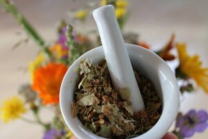 Image of polyherbal supplements being milled in a mortar and pestly