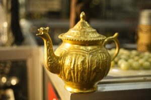 image of a gold teapot on the corner of a table